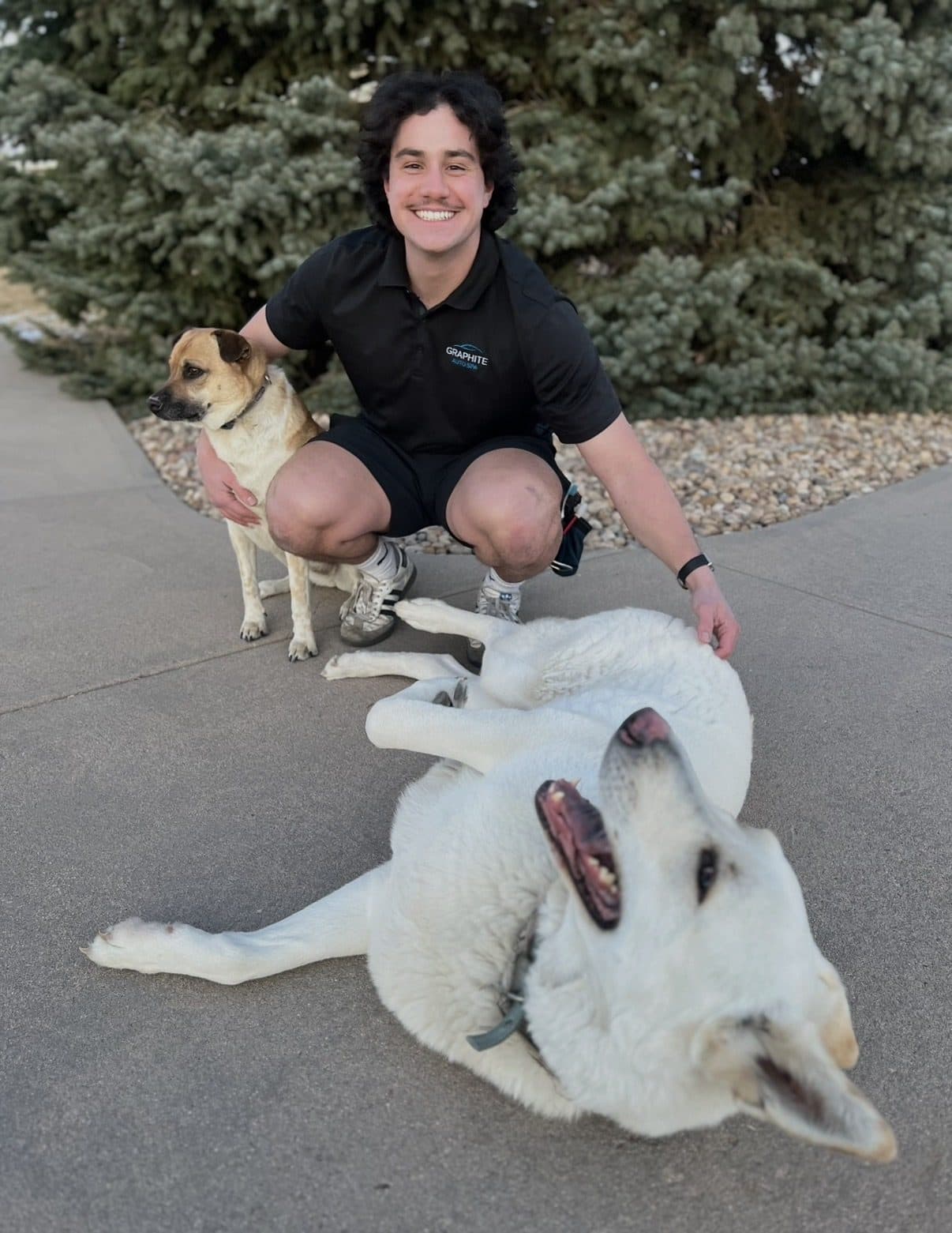 Ethan, owner of Graphite Auto Spa, with his two dogs